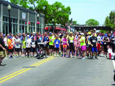 Runners line up in Fields Corner waiting for the pop of the starter’s gun to begin the Dot Day 5K Road Race. Jacob Aguiar photo